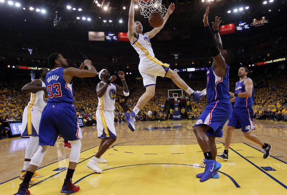 Golden State Warriors' Klay Thompson, center, dunks against the Los Angeles Clippers during the first half in Game 4 of an opening-round NBA basketball playoff series on Sunday, April 27, 2014, in Oakland, Calif. (AP Photo/Marcio Jose Sanchez)