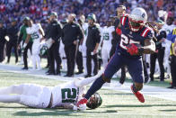 New England Patriots running back Brandon Bolden (25) tries to break free from New York Jets safety Ashtyn Davis (21) during the first half of an NFL football game, Sunday, Oct. 24, 2021, in Foxborough, Mass. (AP Photo/Steven Senne)