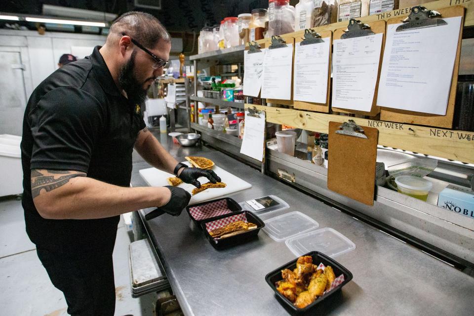 David Flores, kitchen manager at Catering Capers, packages hot meals for an order Wednesday, Jan. 31, 2024.