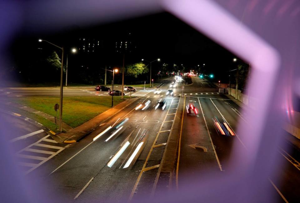 Vehicles travel along Southwest 13th Street, as seen through the Helix Bridge, in Gainesville, Fla., on Friday night, Feb. 19, 2021. 