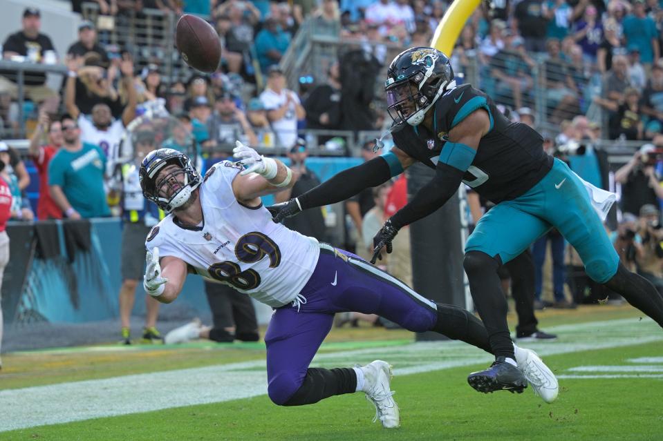 Jacksonville Jaguars safety Andre Cisco (5) breaks up a pass intended for Baltimore Ravens tight end Mark Andrews (89) during the second half of an NFL football game, Sunday, Nov. 27, 2022, in Jacksonville, Fla. (AP Photo/Phelan M. Ebenhack)