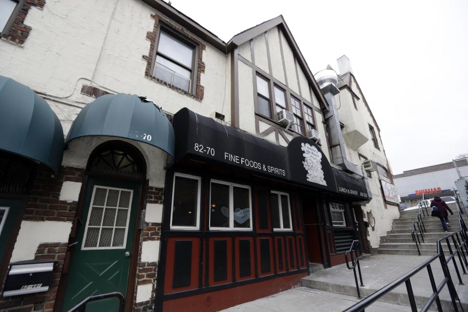 In this March 5, 2014 photo, a pedestrian uses the stairway leading past the entrance to 82-70 Austin street in the Queens borough of New York. The 50th anniversary of the killing of Kitty Genovese's, whose screams could not save her the night she was stalked and killed in the neighborhood on March 13, 1964, is on Thursday. (AP Photo/Frank Franklin II)