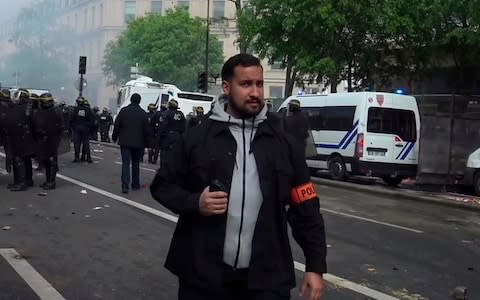 In this grab taken from video on May 1, 2018 provided by Clemont Lanot, French security chief Alexandre Benalla patrols during clashes with activists on the sidelines of the traditional May Day rally, in Paris - Credit: AP