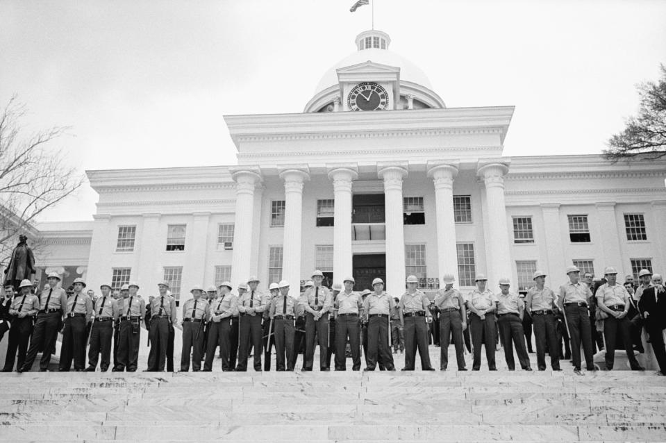 A line of police officers guard the capitol building in Montgomery, Alabama after marchers from Selma arrive at the building to present a petition on voter registration to Governor George Wallace.