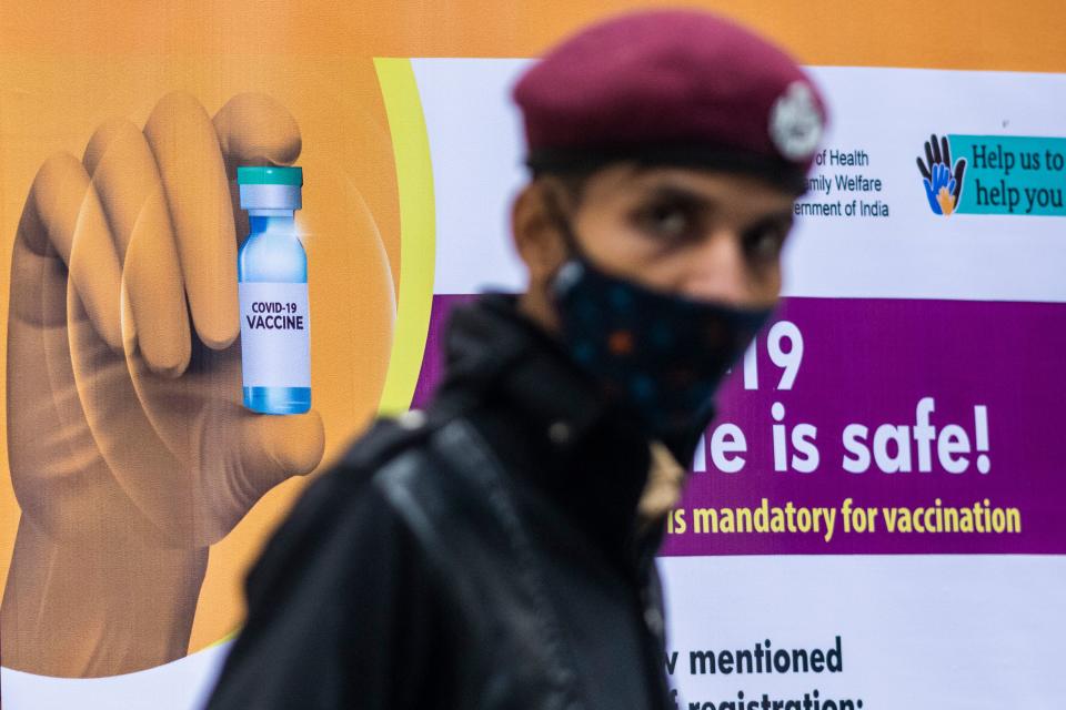 A security guard keeps watch at a Covid-19 coronavirus vaccine centre New Delhi on January 16, 2021. (Photo by Jewel SAMAD / AFP) (Photo by JEWEL SAMAD/AFP via Getty Images)