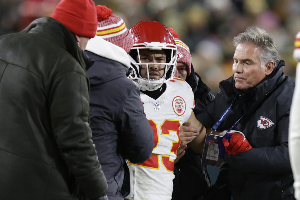 Kansas City Chiefs linebacker Drue Tranquill (23) is helped by medical staff after being injured against the Green Bay Packers during the first half of an NFL football game Sunday, Dec. 3, 2023 in Green Bay, Wis. (AP Photo/Matt Ludtke)