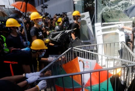 Protesters try to break into the Legislative Council building during the anniversary of Hong Kong's handover to China in Hong Kong