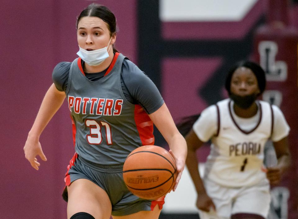 Morton senior forward and Harvard commit Katie Krupa moves the ball up the court against Peoria High on Saturday, Jan. 15, 2022 at Peoria High School.