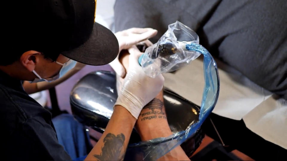 Contest participant Damien Basham getting a Farmer Boys Tattoo. (Courtesy Farmer Boys)