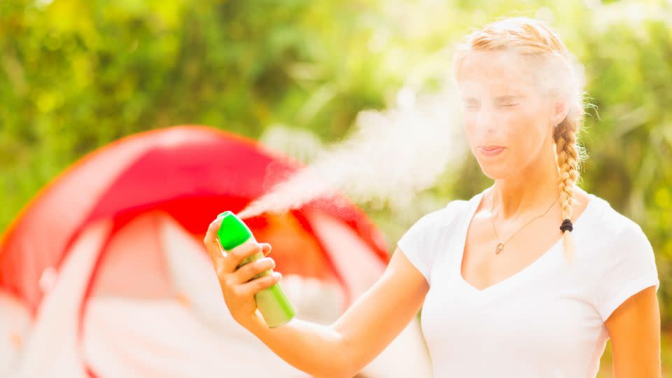 We don't recommend spraying your face like this. Photo: Getty