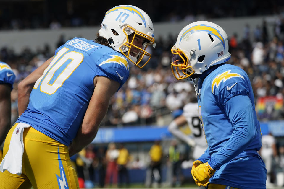 Los Angeles Chargers quarterback Justin Herbert (10) celebrates with wide receiver DeAndre Carter during the first half of an NFL football game against the Las Vegas Raiders in Inglewood, Calif., Sunday, Sept. 11, 2022. (AP Photo/Marcio Jose Sanchez)