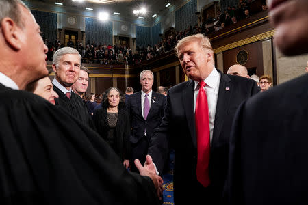 FILE PHOTO: U.S. President Donald Trump shakes hands with Supreme Court Chief Justice John Roberts after the State of the Union address at the Capitol in Washington on February 5, 2019. Doug Mills/Pool via REUTERS/File Photo