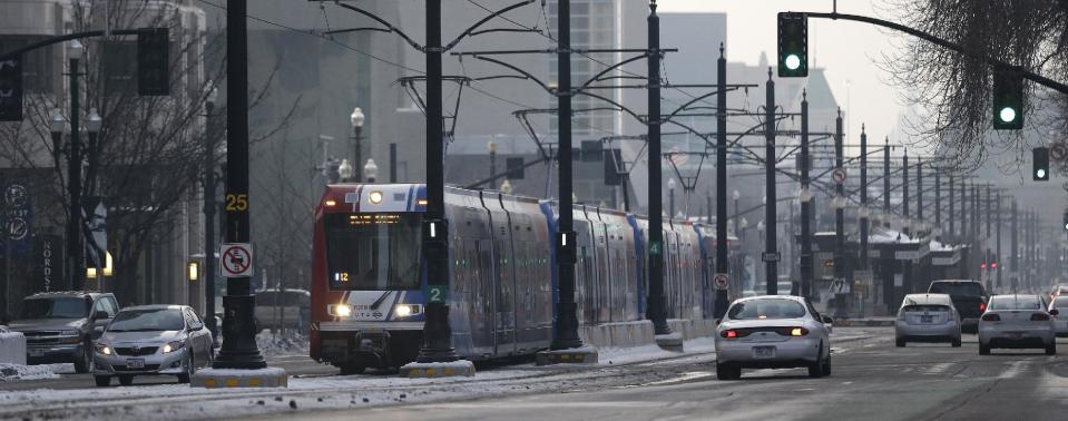 The light rail travels in downtown Salt Lake City Wednesday, Jan. 9, 2013. Built with the 2002 Winter Olympics in mind, Salt Lake City’s light-rail network is free for passengers as it weaves through downtown. Riders can get to and from major attractions such as Temple Square, City Creek Center, Salt Lake City Library, Energy Solutions Arena and the Gateway for free. (AP Photo/Rick Bowmer)