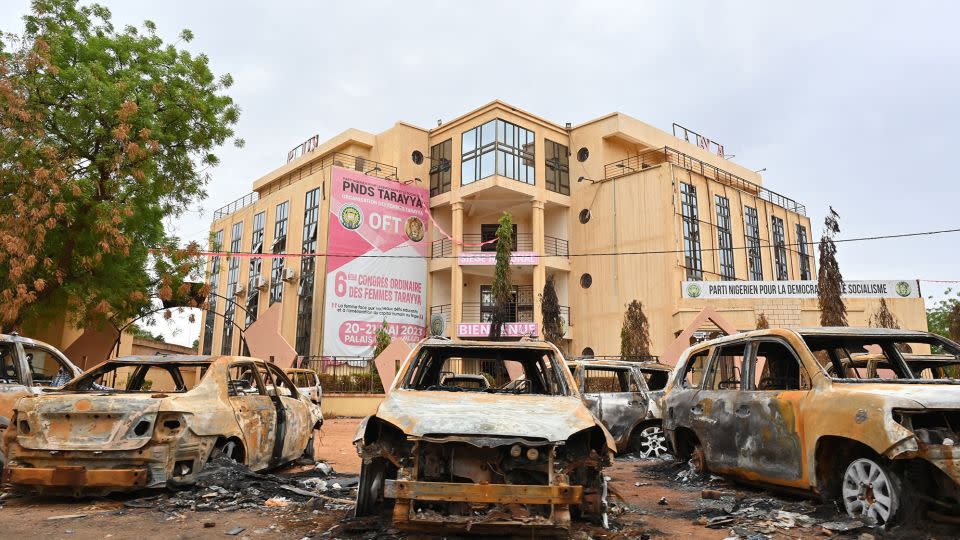 Burned cars are seen on Monday outside the headquarters of the ousted President's political party. - AFP/Getty Images