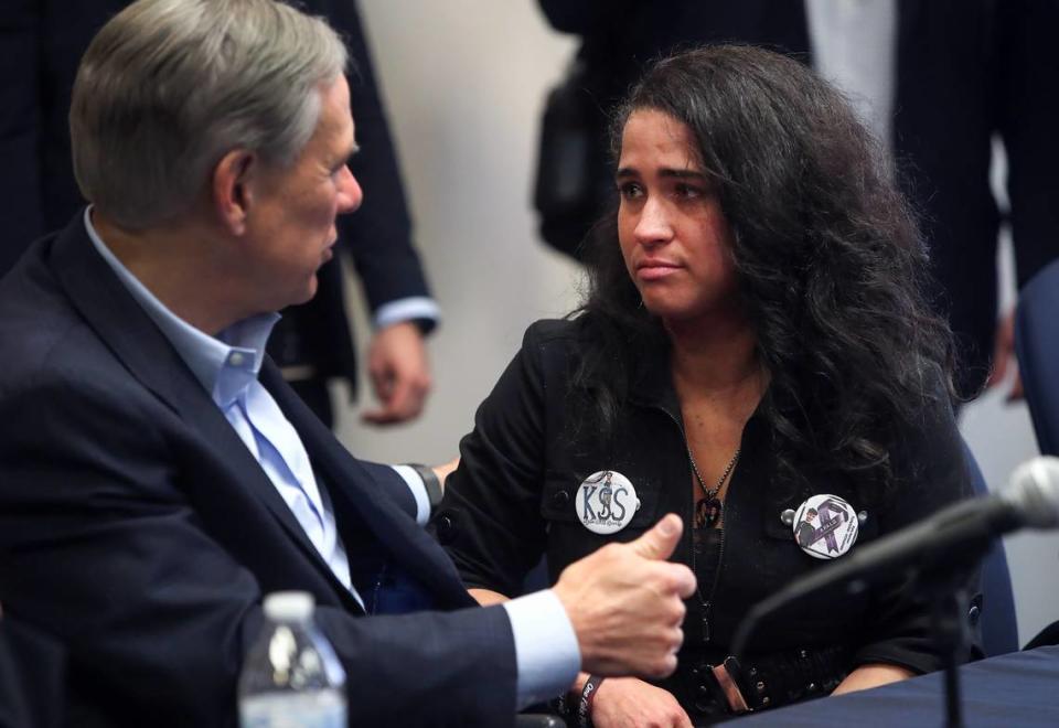 Stephanie Hellstern speaks to Gov. Greg Abbott following a press conference to discuss the fentanyl crisis on Feb. 15, 2022. Hellstern’s son, Kyle Sexton, 16, died of an accidental fentanyl overdose in 2020.