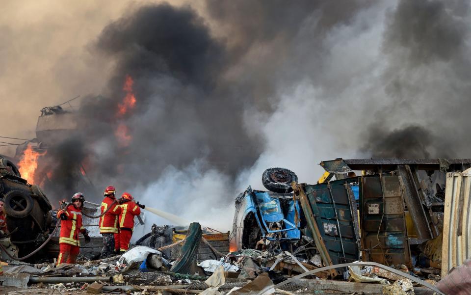 Firefighters tackle the blaze. Many were incinerated by the second blast - WAEL HAMZEH/EPA-EFE/Shutterstock