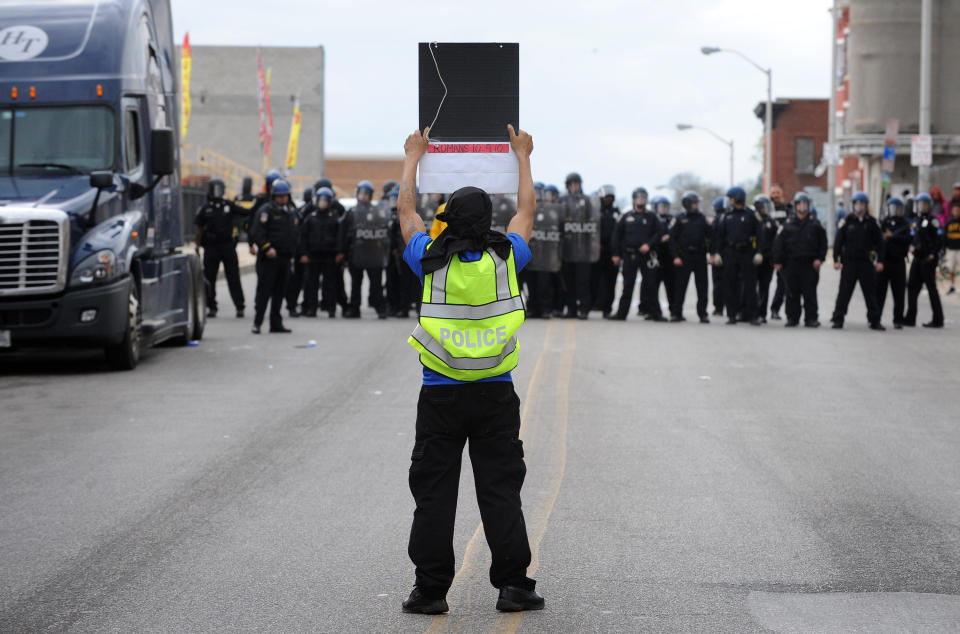 A protester with a stolen police vest taunts Baltimore police officers on Pennsylvania Avenue during riots on Monday, April 27, 2015, Baltimore, MD, USA. Photo by Jerry Jackson/Baltimore Sun/TNS/ABACAPRESS.COM