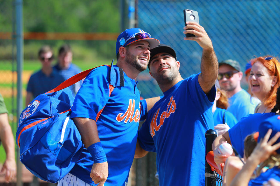 <p>New York Mets catcher Kevin Plawecki poses for a photo with a fan after spring training workouts in Port St. Lucie, Fla., Feb. 23, 2018. (Photo: Gordon Donovan/Yahoo News) </p>