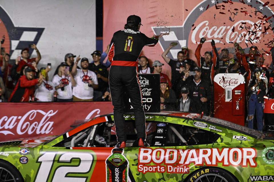 Ryan Blaney, center, celebrates on his car in Victory Lane after winning a NASCAR Cup Series auto race at Charlotte Motor Speedway, Monday, May 29, 2023, in Concord, N.C. (AP Photo/Matt Kelley)