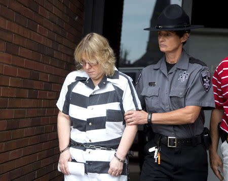 Joyce Mitchell is escorted out of the court house after pleading guilty at Clinton County Court, in Plattsburgh, New York July 28, 2015. REUTERS/Christinne Muschi
