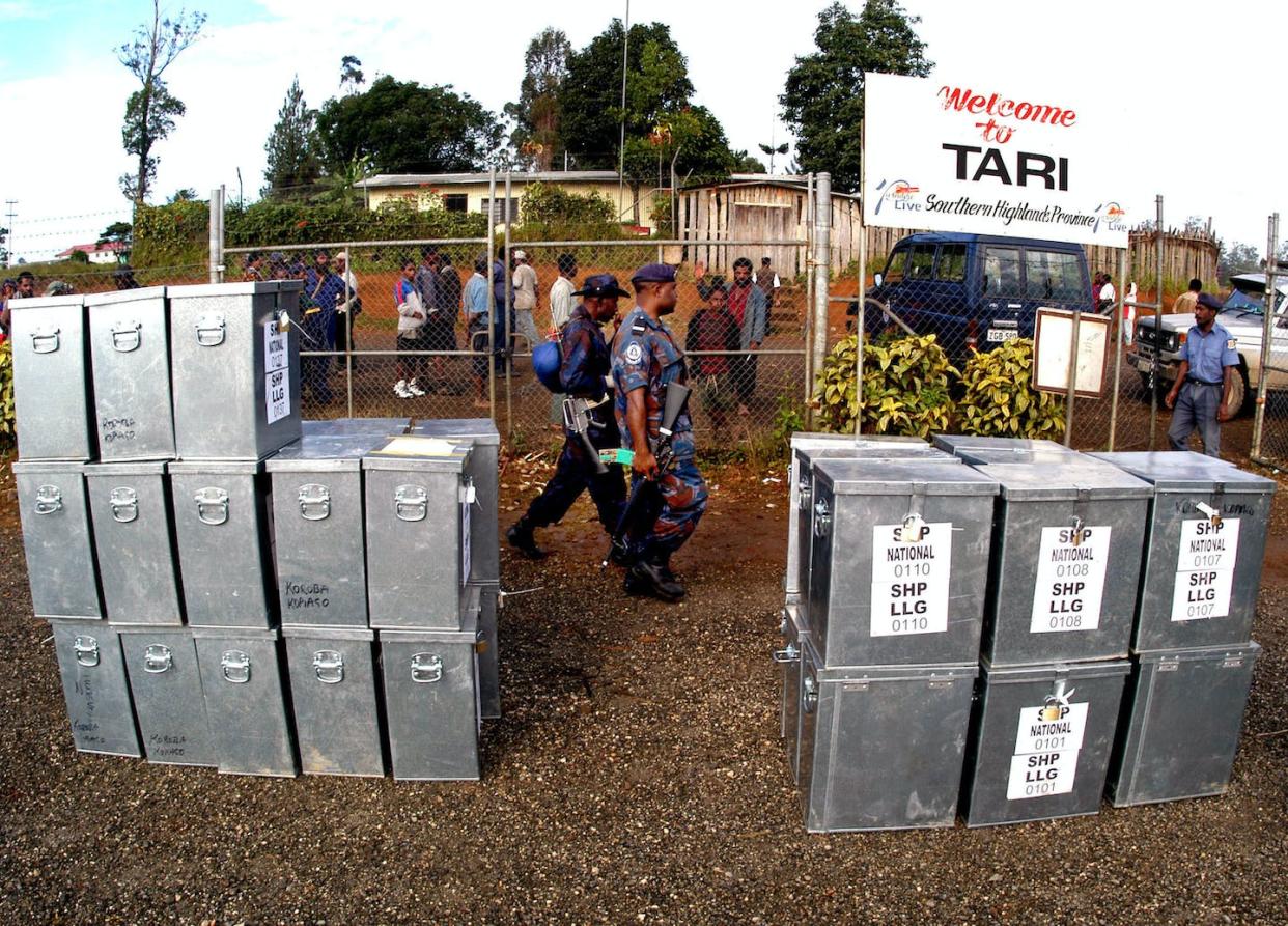 Paramilitary police and soldiers patrol ballot boxes at Tari airport, Southern Highlands, PNG AAP Image