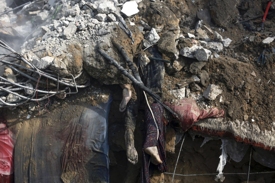 Bodies of dead Palestinians are seen under the rubble of a destroyed house after Israeli airstrikes on Gaza City, Tuesday, Oct. 24, 2023. (AP Photo/Abed Khaled)