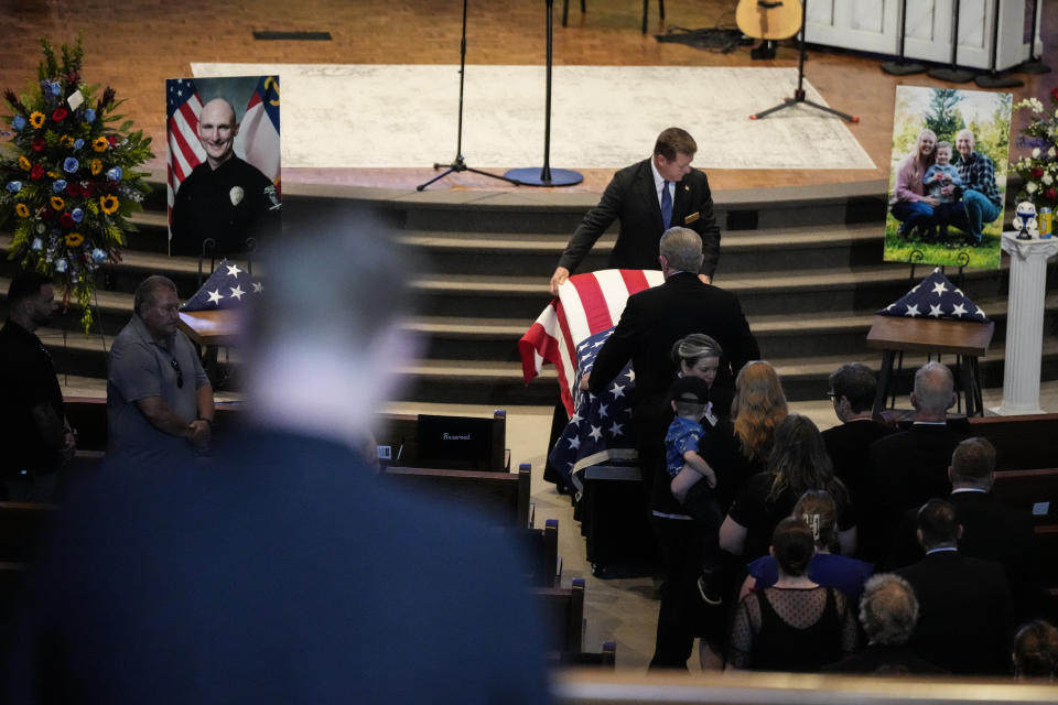 The casket is moved during a memorial service for Officer Joshua Eyer, Friday, May 3, 2024, in Charlotte, N.C. Police in North Carolina say a shootout that killed Eyer and wounded and killed other officers began as officers approached a home to serve a felony warrant on Monday. (AP Photo/Chris Carlson)