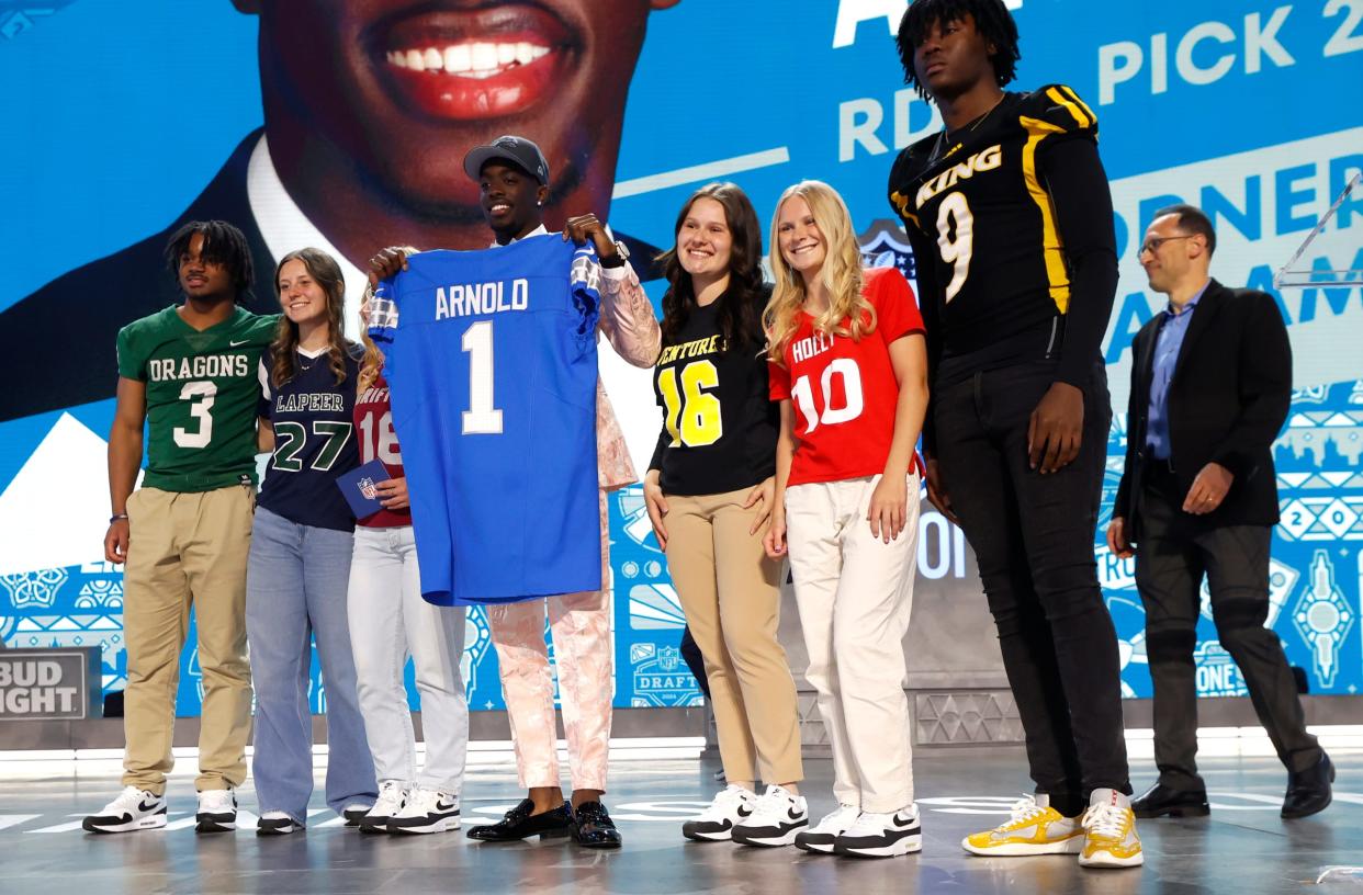 Terrion Arnold, a cornerback from the University of Alabama, shows off his Detroit Lions jersey with metro Detroit athletes after he was picked in the first round of the 2024 NFL draft at the NFL draft theater in Detroit on Thursday, April 25, 2024.