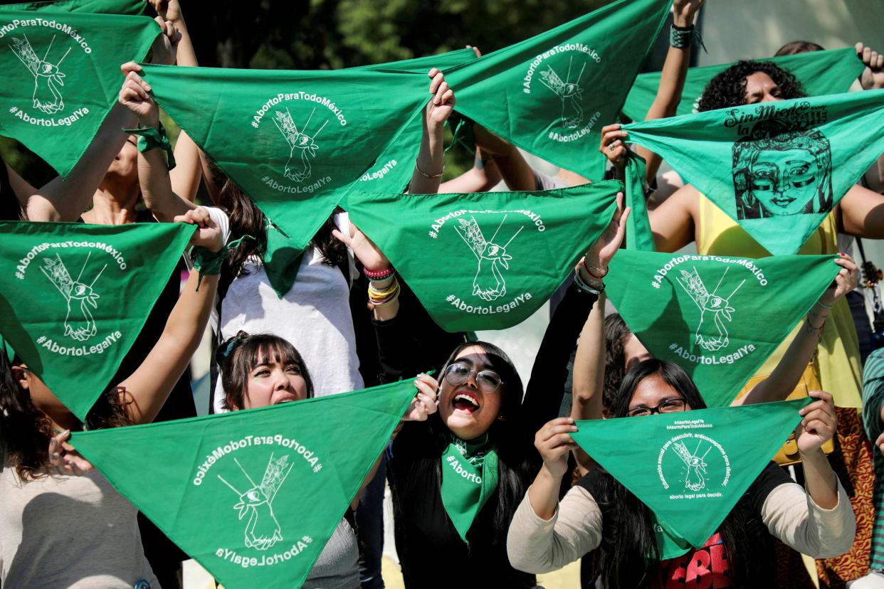 Women hold green handkerchiefs during a protest in support of legal and safe abortion in Mexico City (REUTERS)