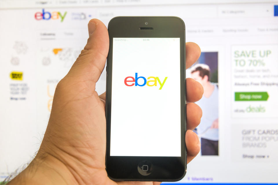New York, U.S.A. - August 13, 2015: Ebay home page on the screen of a iphone 5 smart phone and in browser window in the background. eBay is the most visited an online auction and shopping website in US.