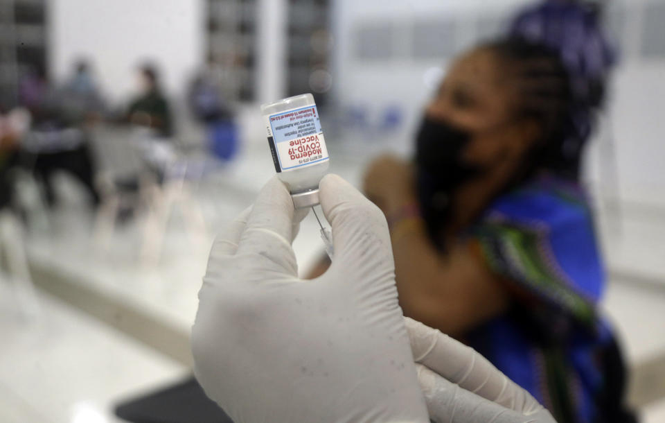 A nurse prepares the Moderna coronavirus vaccine at the health center in Lagos, Nigeria Wednesday, Aug. 25, 2021. Nigeria has begun the second rollout of COVID-19 vaccines as it aims to protect its population of more than 200 million amid an infection surge in a third wave of the pandemic. (AP Photo/Sunday Alamba)