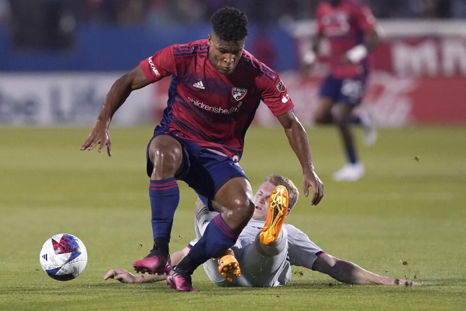 Sporting Kansas City's John Nelson, bottom, tries to tackle FC Dallas' Geovane Jesus, top, during the first half of an MLS soccer match Saturday, May 6, 2023, in Frisco, Texas. (AP Photo/LM Otero)