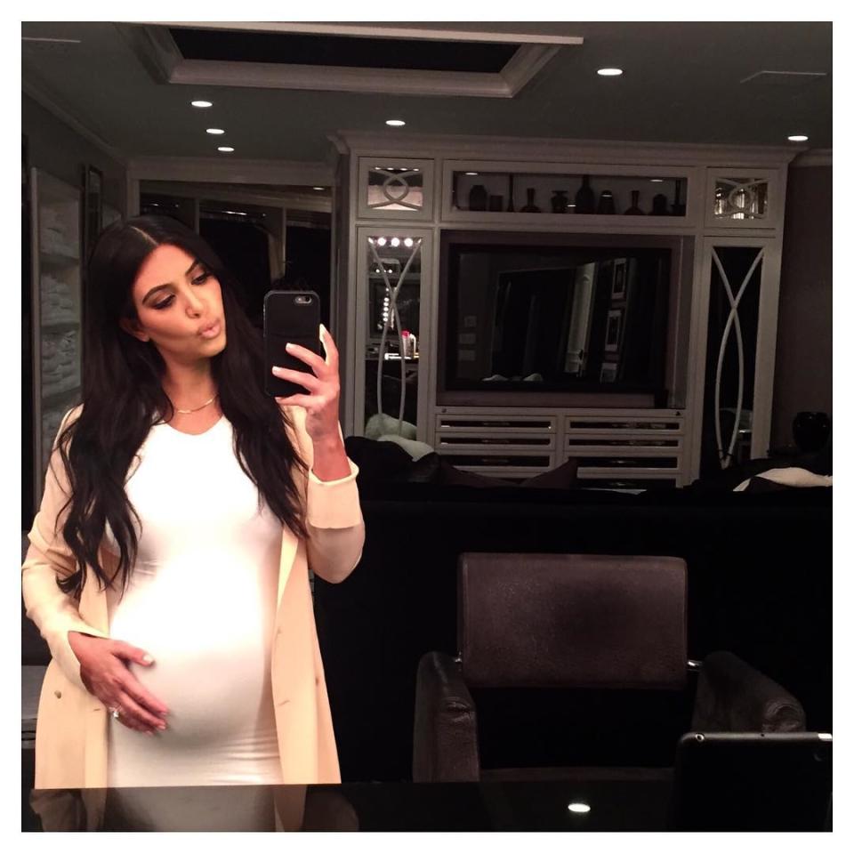 Kim Kardashian is glowing while her baby bump is growing! The pregnant reality star posted an adorable Instagram picture of herself gently touching her burgeoning belly while sporting a tight white dress on Monday. <strong> PHOTOS: Kim Kardashian's Second Pregnancy Styles </strong> "Good night baby," Kim captioned the sweet snap. Last month, the 34-year-old soon-to-be mother of two spoke to ET about how this pregnancy is different from her first with daughter North West, 2. <strong> MORE: North West Takes After Kim Kardashian </strong> "I want to wear things that make me feel good about myself and still feel sexy," Kim, who is expecting a boy, said. "Just because you're pregnant doesn't mean you can't wear heels and you have to wear sweats all day long. I like to still feel like myself." Kim and her husband, Kanye West, first revealed they were expecting during a promo that ran at the end of the mid-season finale of <em>Keeping Up With the Kardashians</em>. Check out 10 more celebrity baby bumps we've been keeping an eye on this summer in the video below. 