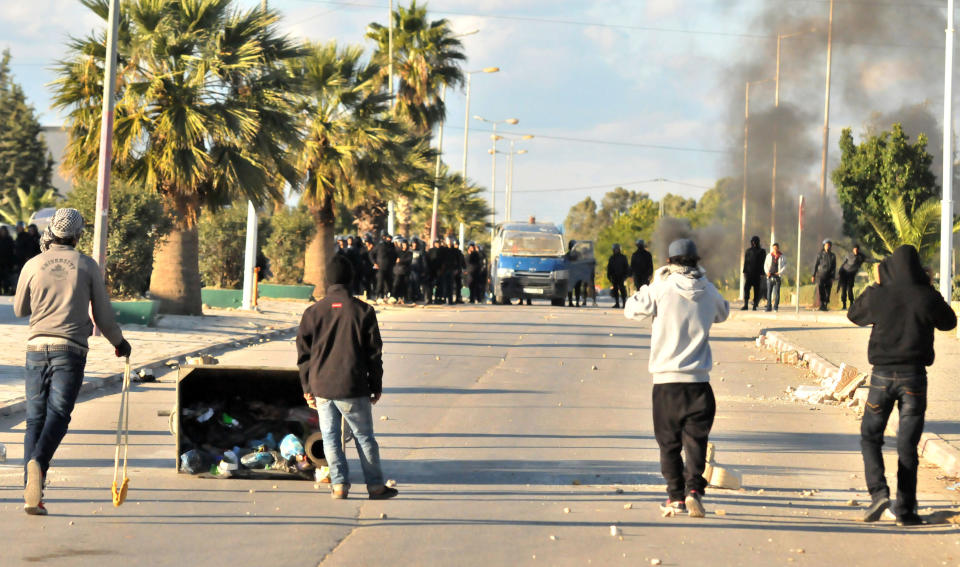 Demonstrators face government forces in Siliana, northern Tunisia, Thursday, Nov. 29, 2012. Tunisia's army intervened in a third day of violent clashes in a northern town between police and striking residents who are demanding jobs and investment. After two days of battles that a hospital said left more than 300 people injured, police pulled out of Siliana Wednesday night. Witnesses said 15,000 people marched through the town Thursday demanding the governor's resignation. (AP Photo)
