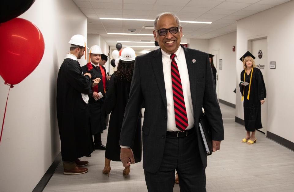 Neville Pinto, the 30th president of the University of Cincinnati, walks down the hall in the Fifth Third Arena to oversee one of four graduations, Friday, April 29, 2022. He's been in the position since 2017.