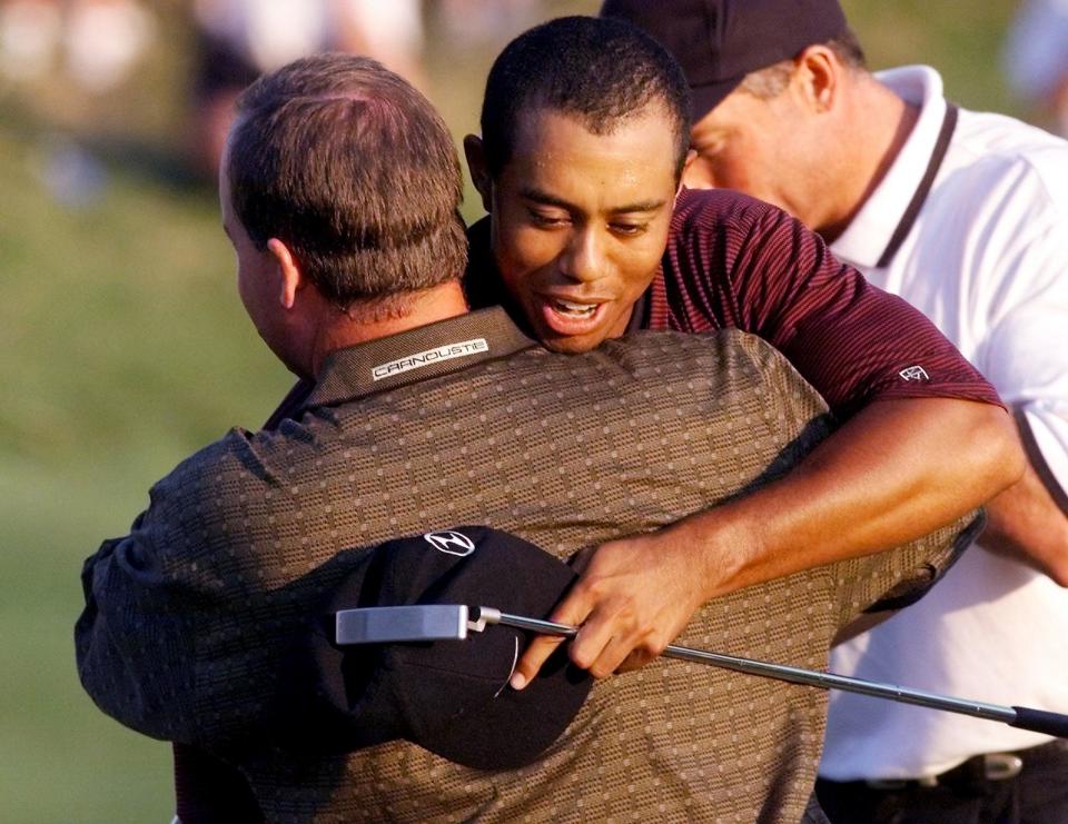 Golfer Tiger Woods of the US hugs Bob May (L) on the 18th hole after their playoff 20 August, 2000 in the 82nd PGA Championship at Valhalla Golf Club in Louisville, KY. Woods won a three hole playoff with Bob May to win his third major tournament of the year.   (ELECTRONIC IMAGE)  AFP PHOTO/Jeff HAYNES (Photo by JEFF HAYNES / AFP) (Photo by JEFF HAYNES/AFP via Getty Images)