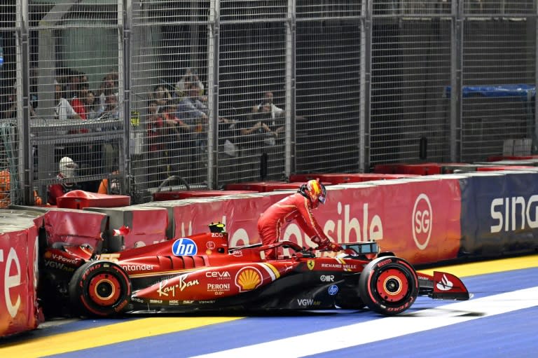 Ferrari's Spanish driver Carlos Sainz climbs out of his car after a crash during qualifying (MOHD RASFAN)