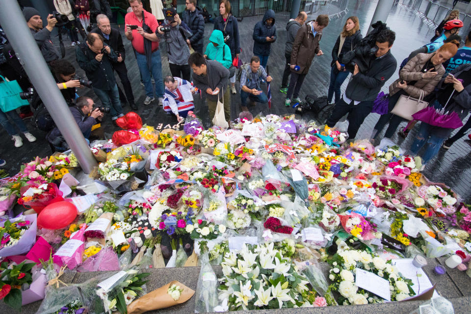 Members of the public lay flowers following a vigil at City Hall on June 05, 2017 in London, England. V