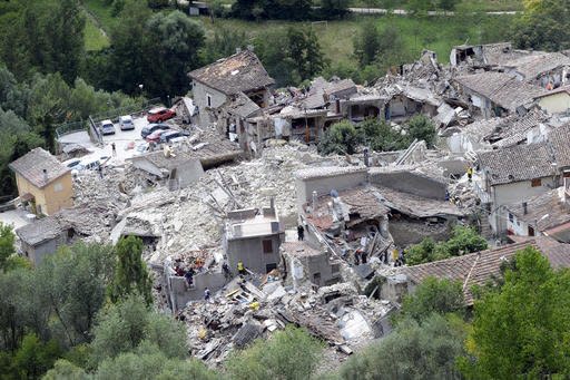 Rescuers search through debris of collapsed houses in Pescara del Tronto, Italy, Wednesday, Aug. 24, 2016.  The magnitude 6 quake struck at 3:36 a.m. (0136 GMT) and was felt across a broad swath of central Italy, including Rome where residents of the capital felt a long swaying followed by aftershocks. (AP Photo/Sandro Perozzi)