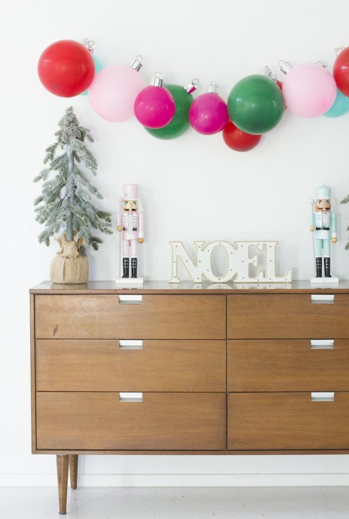 <p>DIY your own holiday banner by transforming balloons into colorful baubles. </p><p><em><a href="https://bestfriendsforfrosting.com/christmas-balloon-ornament-banner/" rel="nofollow noopener" target="_blank" data-ylk="slk:Get the tutorial at Best Friends for Frosting »" class="link ">Get the tutorial at Best Friends for Frosting »</a></em></p>