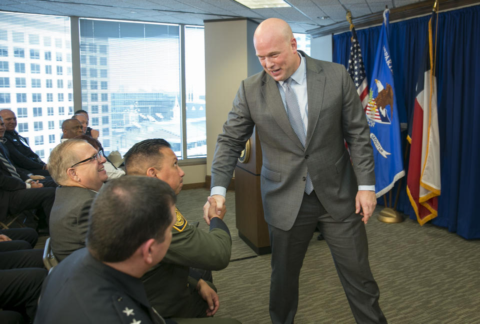 Acting U.S. Attorney General Matthew G. Whitaker shakes hands after speaking to area law enforcement officials at the U.S. Attorney's Office for the Western District of Texas in Austin, Tuesday, Dec. 11, 2018. (Jay Janner/Austin American-Statesman via AP)