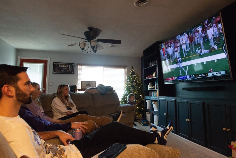 All eyes were on the second-half kickoff as, from left, Joel Garver, Clay Griffiths, Abby Griffiths and Kelsey Garver watch Kansas State play Alabama on Saturday in the Sugar Bowl. The group gathered in the Garvers' basement.