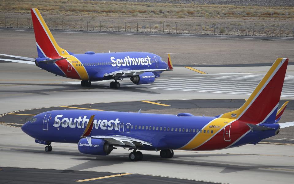 This Wednesday, July 17, 2019 photo shows Southwest Airlines planes at Phoenix Sky Harbor International Airport in Phoenix. Southwest Airlines Co. reports earnings Thursday, July 25. (AP Photo/Ross D. Franklin)