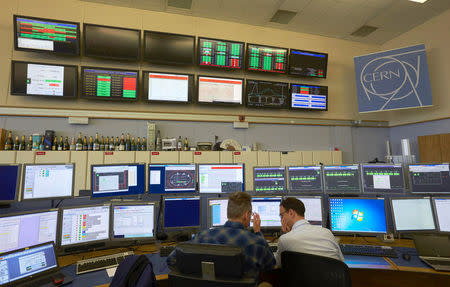 Technicians work in the Control Centre of the Large Hadron Collider (LHC) at the European Organisation for Nuclear Research (CERN) in Prevessin, France, near Geneva in Switzerland March 11, 2015. REUTERS/Denis Balibouse