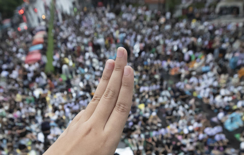 A pro-democracy demonstrators raises a three-finger salute, a symbol of resistance, as hundreds gather in a business district in Bangkok, Thailand, Friday, Oct. 16, 2020. Thailand’s prime minister has rejected calls for his resignation as his government steps up efforts to stop student-led protesters from rallying in the capital for a second day in defiance of a strict state of emergency. (AP Photo/Sakchai Lalit)