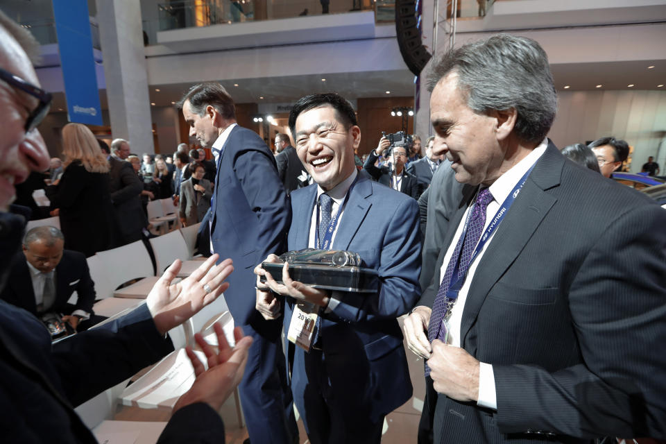 Yong-woo William Lee, left, President and CEO of Hyundai Motor North America and Brian Smith, Chief Operating Officer, Hyundai Motor America hold the North American SUV of the Year trophy for the Hyundai Kona during media previews for the North American International Auto Show in Detroit, Monday, Jan. 14, 2019. (AP Photo/Paul Sancya)