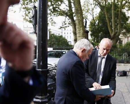 France Foreign Minsiter Jean-Marc Ayrault receives papers from an aide as he arrives at 10 Carlton House Terrace in central London, where representatives from Britain, China, France and energy company EDF will sign an agreement to build and operate a new nuclear power station at Hinkley Point, Britain, September 29, 2016. REUTERS/Peter Nicholls