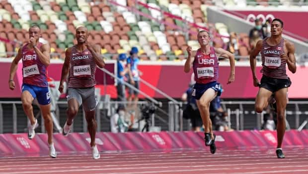 Zachery Ziemek, left, of the United States, Damian Warner of Canada, Steven Bastien of the U.S. and Pierce LePage of Canada compete in their decathlon 100-metre heat on Wednesday.  (Martin Meissner/The Associated Press - image credit)