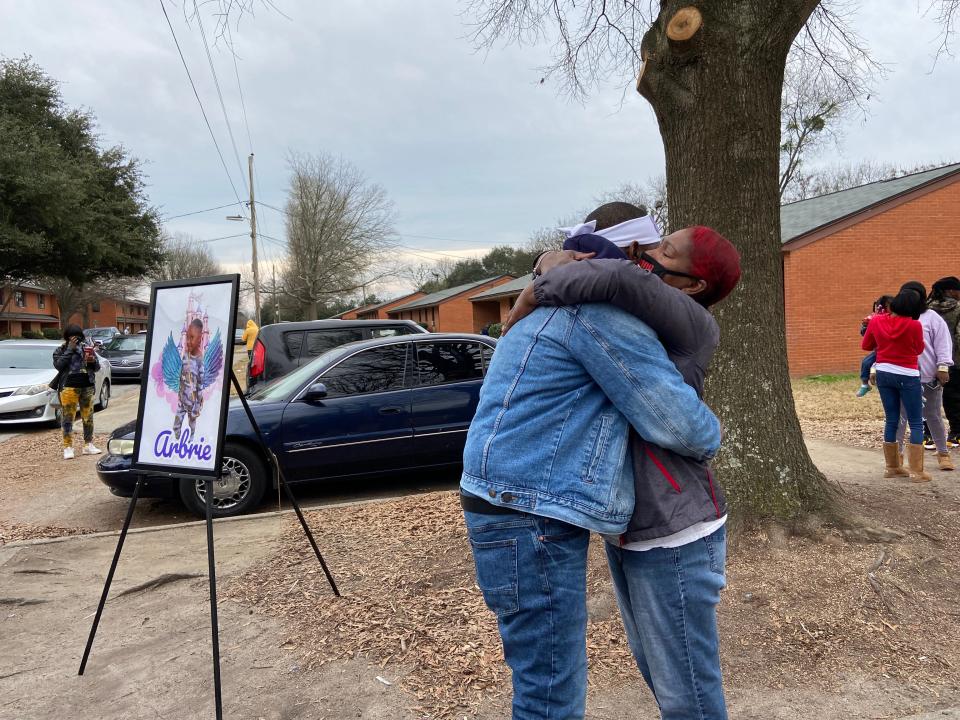 A woman hugs Arthur Anthony, the father of 8-year-old Arbrie Anthony, after a march in Arbrie's memory Saturday, January 15, 2022.