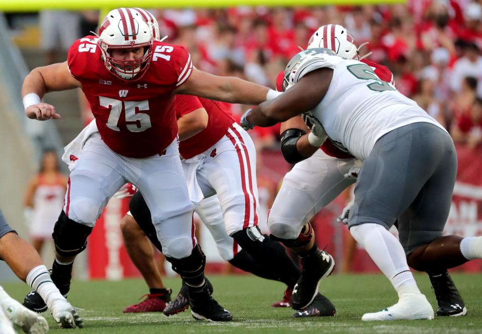 Wisconsin offensive lineman Joe Tippmann (75) looks for someone to block during the first quarter of their game against Eastern Michigan Saturday, September 11, 2021 at Camp Randall Stadium in Madison, Wis.